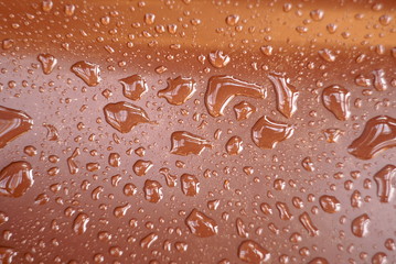 drops of water on a brown surface