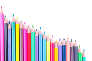 Many colored pencils on white isolated background. School supplies. View from above