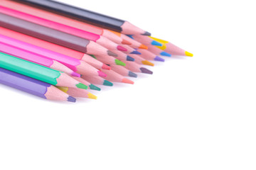 Many colored pencils on white isolated background. School supplies.