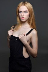 Naklejka premium Sexy woman with red hair in black clothes