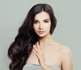 Naklejka premium Young Beautiful Woman with Healthy Wavy Hairstyle, Natural Makeup and Fresh Skin, Hair careand Facial Treatment.