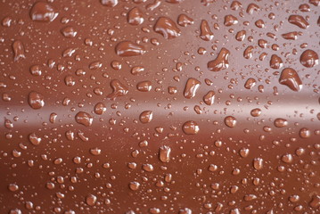 drops of water on a brown surface