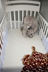 Obraz na płótnie Canvas Baby crib with plush toys for infant play and napping
