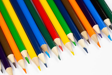 Color pencils lined up in a row against a white background.