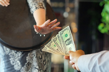 The hand of the waitress does not take the tip. The waitress refuses to receive a tip from the...
