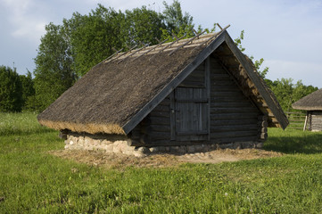 Ancient Belarusian (Russian) village, wooden cellar with authentic roof