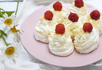 cakes made of egg white and whipped white cream with raspberries