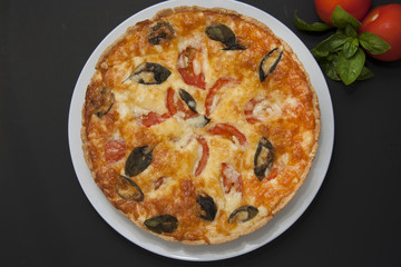 Quiche Tart Pie with Tomatoe, ,Spinach, Cheese. Foods and Pastries. Isoalted, Black Background. Top View.