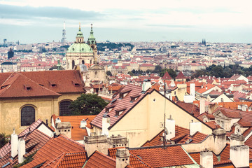 Obraz premium Beautiful views of Prague's tiled roofs and the Cathedral of St. Mikulas.