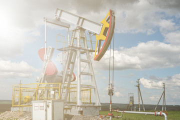 Oil and natural gas production tower with bright sunlight, glare