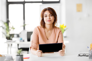 business, technology and people concept - businesswoman with tablet pc computer working at office