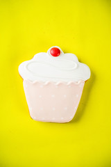 Sweets creative lay out, dessert concept with lollipops, jellies, candy, cookies donuts and cupcakes, bright yellow background top view copy space