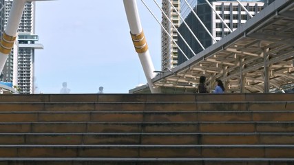 Time lapse of moving business people on the street of urban city with blue sky in background. Finance concept.