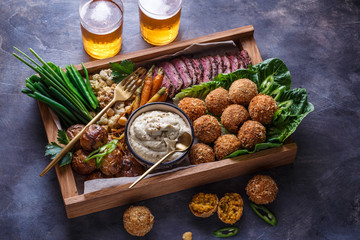 Arabian meze food falafel, beef, babaghanous, fried cauliflower, beans.