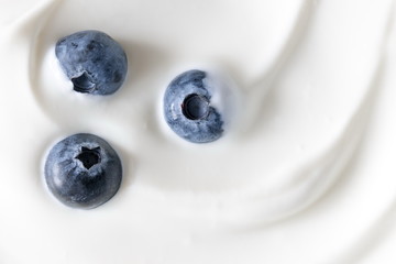 Yogurt and fresh berries blueberries, background. Flat lay, top view, copy space 