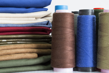 colorful bobbin on the white background for textile concept.