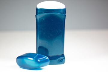 A blue deodorant stick on a white surface