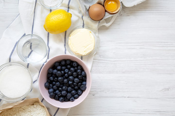 Raw ingredients for cooking blueberry pie with copy space. Overhead, top view, from above.