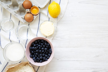 Raw ingredients for cooking blueberry pie, view from above. Overhead, top view, flat lay.