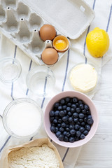 Raw ingredients for cooking blueberry pie, view from above. Overhead, top view.