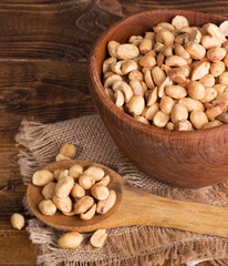 Dry Roasted Peanuts in a Wooden Bowl and Spoon