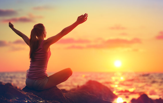 Relaxation And Yoga At Sunset - Girl With Open Arms Looking Ocean
