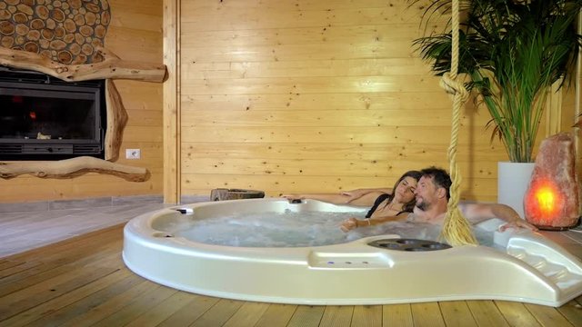 Couple in romantic jacuzzi relaxing in vacation