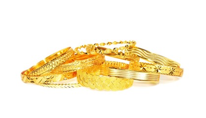 Gold bracelets on white