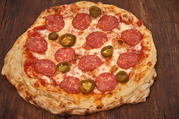 Homemade fresh delicious gourmet pizza,Tasty italian pizza isolated on wooden table, closeup