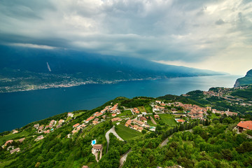 View of the Lake Garda from Tremosine, Italy.Panorama of the gorgeous Garda lake surrounded by mountains in the springtime on a cloudy day and a strong storm