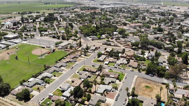 Soaring over small town with farmland