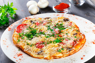 Omelette with slices ham, mushrooms, greens, cheese and tomato on dark wooden background. Hot and healthy breakfast, pizza. - obrazy, fototapety, plakaty
