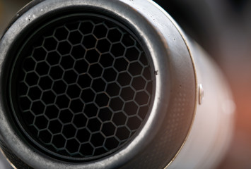 Close-up detail exhaust pipe of big bike. Hexagon unique pattern of racing motorcycle exhaust pipe....