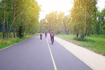 Family on bikes riding on a Park Tatyshev path