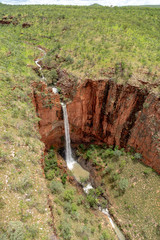 Aerial Portrait view of single drop unamed waterfall in the Cockburn Ranges, El Questro Resort, Kimberley, Western Australia.