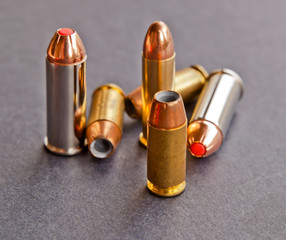 Three different handgun bullets, 44spl, 38spl and 40 caliber together on a black background