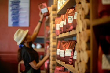 Raw Coffee Bean in sealed bag laying in shelf, Barista prepare in store