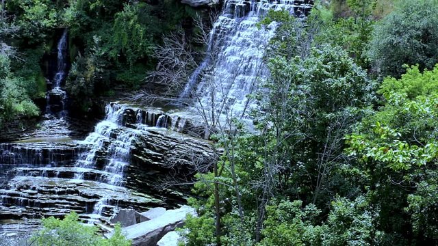 Cascading waterfall landscape hidden deep in the forest.  Panoramic aerial view of a spectacular secrete waterfall. Natural environment.  