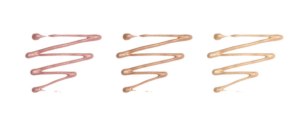 Liquid foundation color sample smeared on white background. Foundation with shimmer isolated. Makeup base.