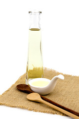 Olive oil in white spoon on white background isolated with copy space