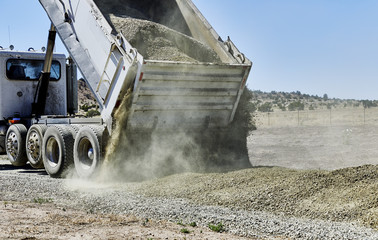 Dump Truck spreading Gravel on Driveway
