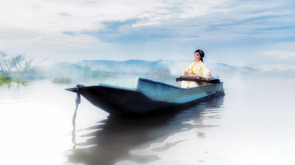Chinese girl is playing the traditional Chinese musical instrument on the boats in the  lake...