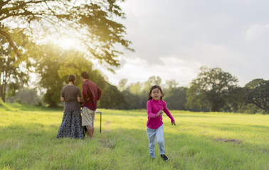 Fototapeta premium a little girl sad with her parents are arguing; Attractive little asia girl is looking angry away crossed eyes looking unhappy while playing in the garden.