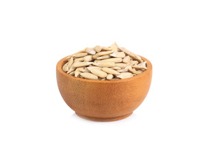 Sunflower seeds in a wooden cup isolated on white background.