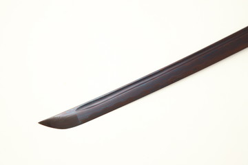 Folded steel blade of Japanese sword  (Chinese made) red color by titanium coated isolated in white background