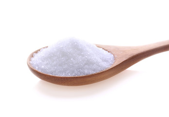 Fototapeta na wymiar White sugar in a wooden spoon isolated on white background.