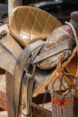rustic horse saddle. This worn out leather saddle shows years of intense use