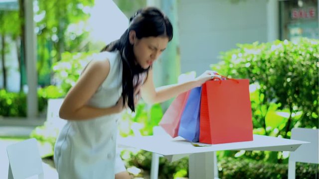 Young woman having heart attack at the garden of mall