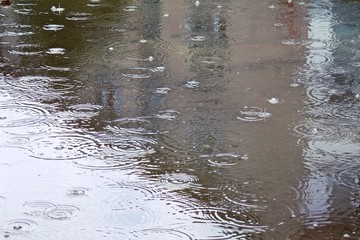 the texture of the water on which the rain falls with the reflection of the house