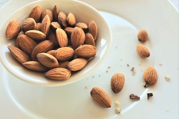 Almond nuts in a white bowl.